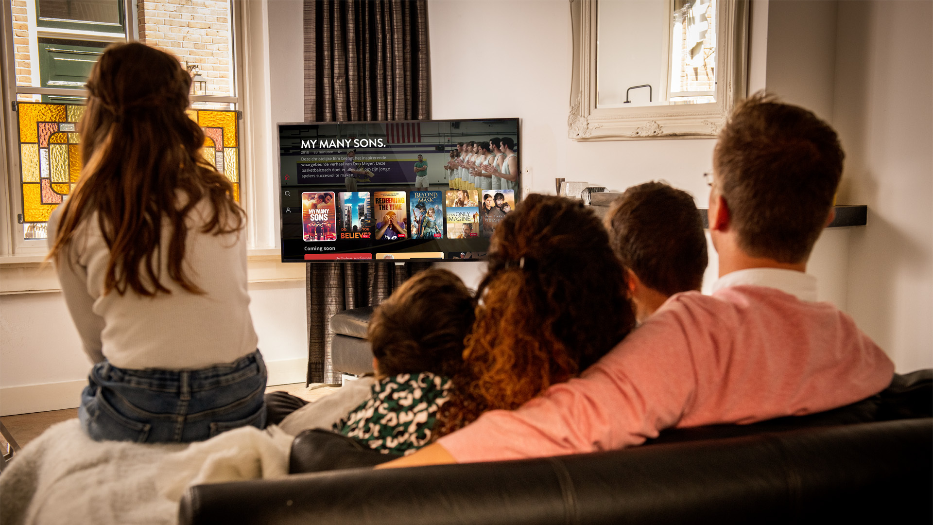 Family watching New Faith Network on their TV